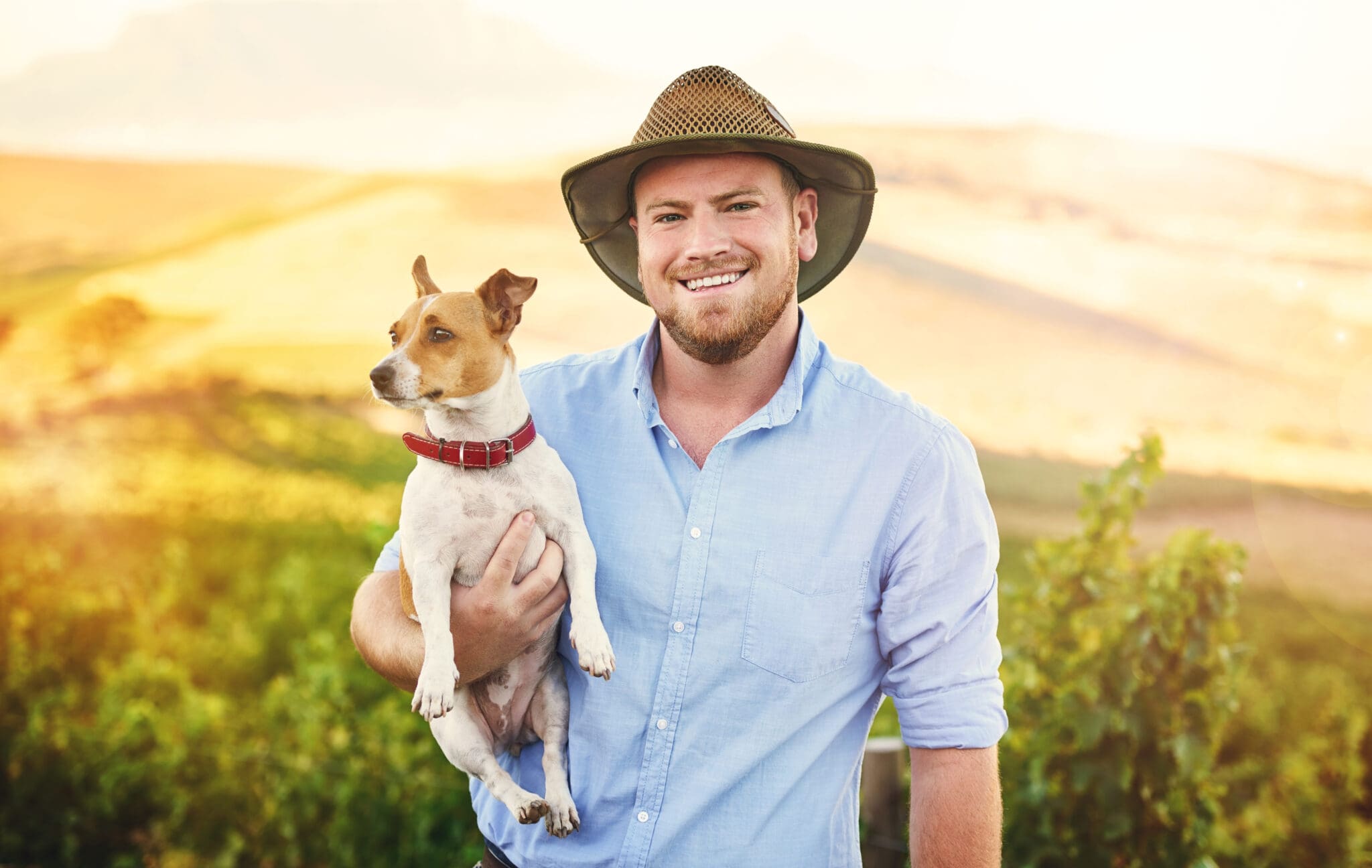 Shot of a happy farmer holding his dog