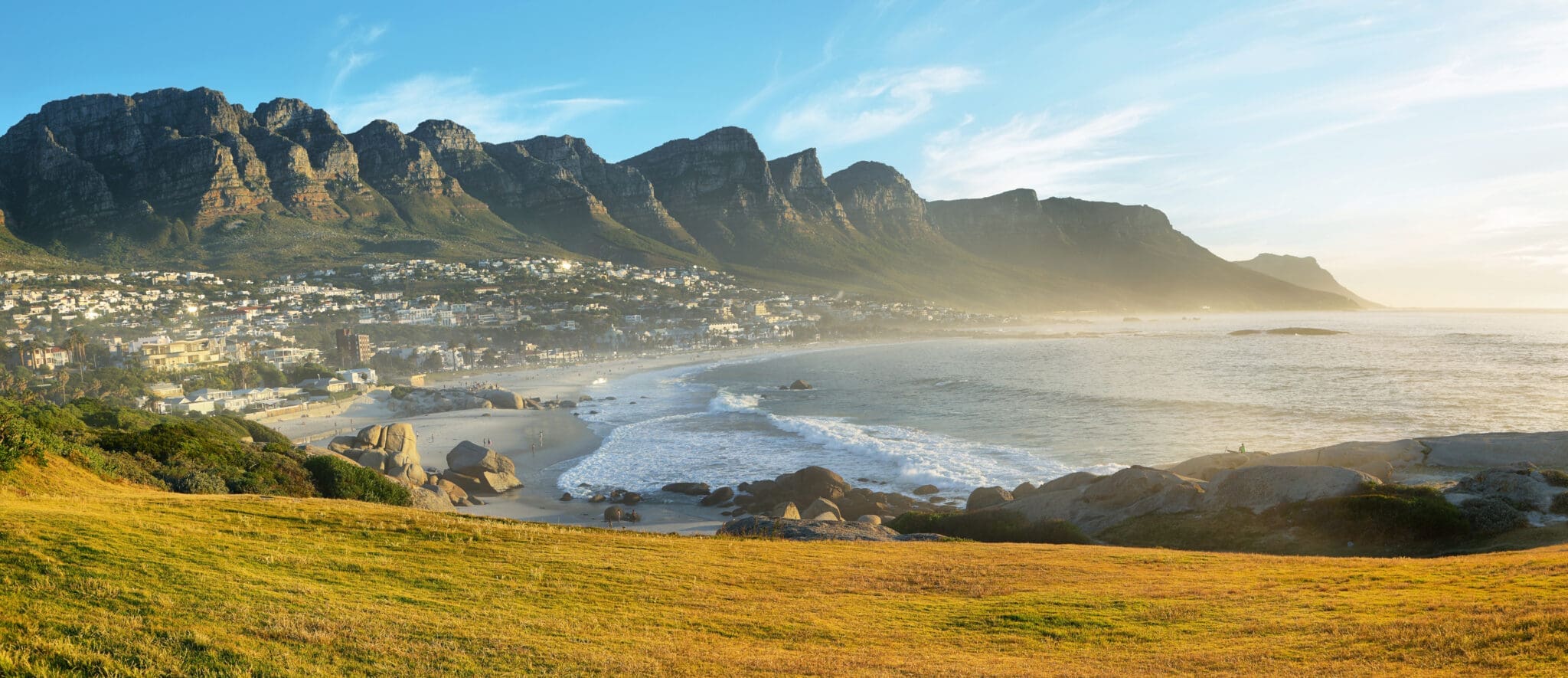 Camps Bay Beach in Cape Town, South Africa, with the Twelve Apostles in the background.